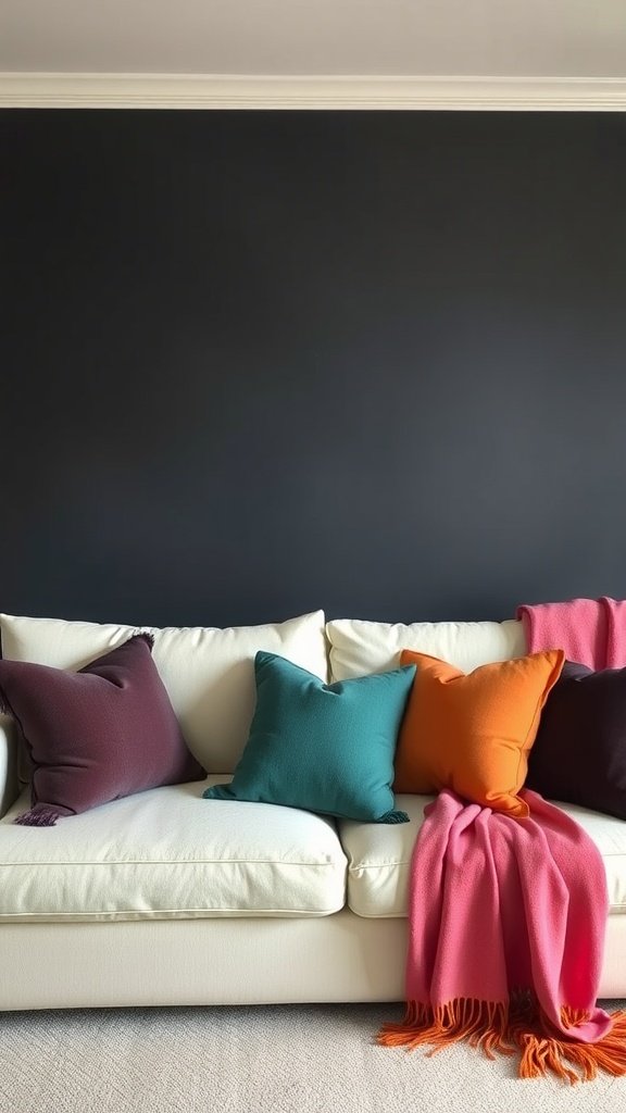 A cozy white couch adorned with colorful pillows and a vibrant throw blanket against a dark wall.